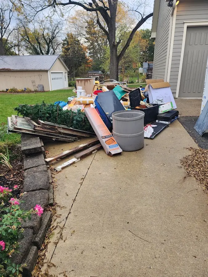 Dumpster being loaded with debris for 30 Yard Dumpster Rental in Birch Run
